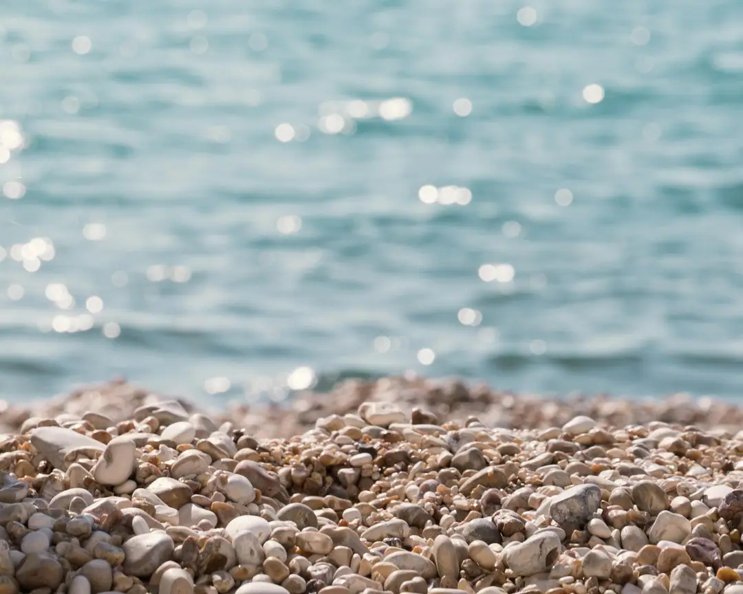 Smooth pebbles and sea at Baia delle Zagare